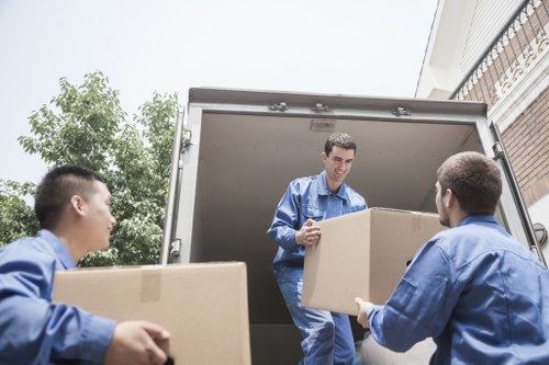 Professional movers handling boxes and furniture in Barbican