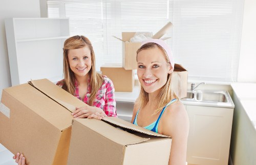 Local removals team handling boxes and furniture in Barbican