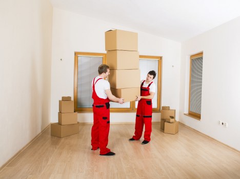 Careful loading of boxes and furniture into a moving van in Barbican
